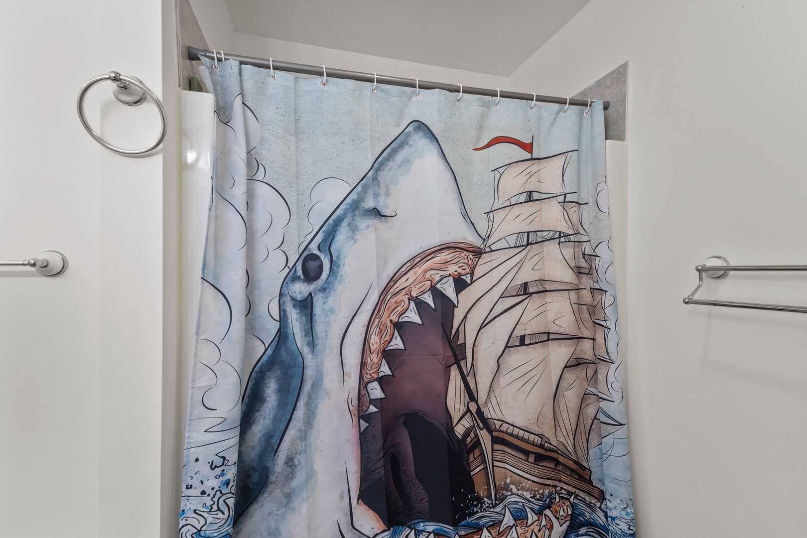 Step into your private bathroom featuring a fun nautical-themed shower curtain that adds personality to your refreshing space.