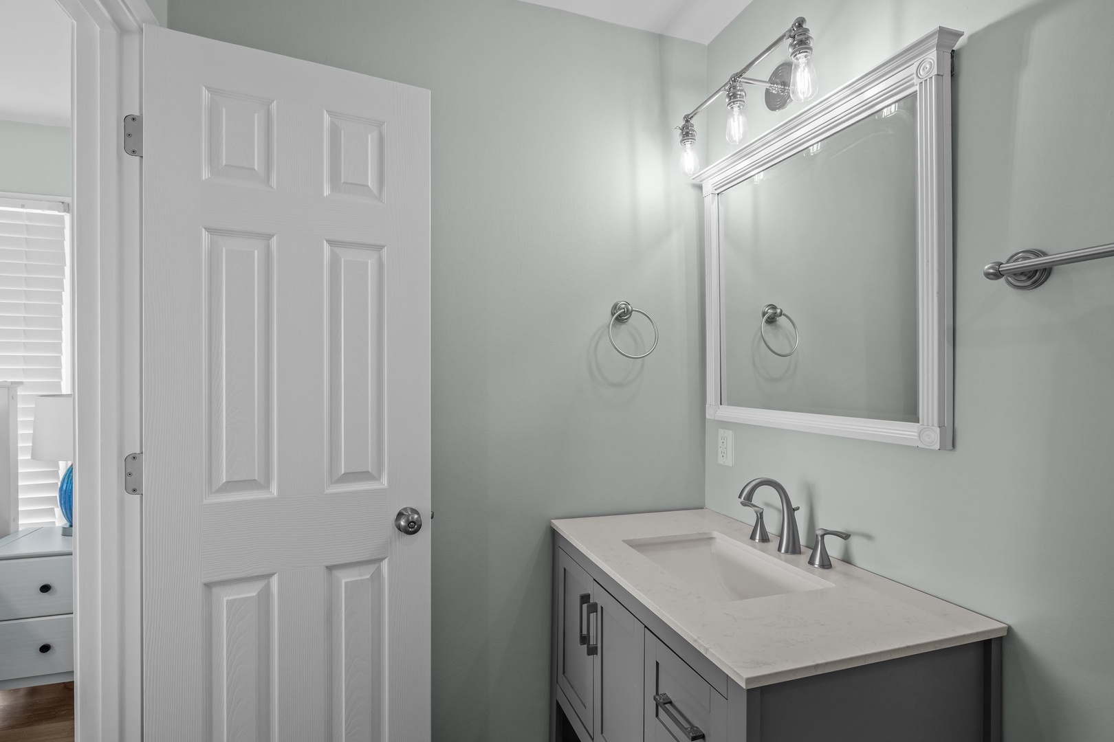 Step into your beautifully refreshed bathroom with modern vanity, perfect lighting, and soothing sage walls that create a spa-like retreat.