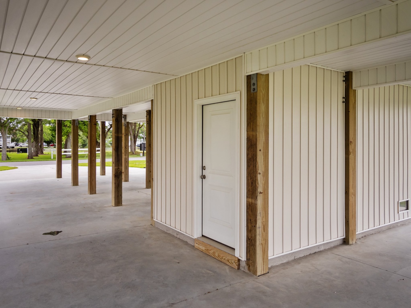 Covered pavilion area with convenient storage access and peaceful park views in the background.
