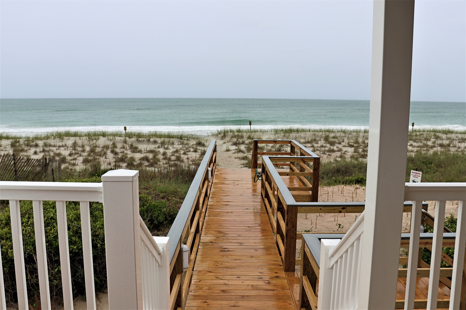 Oceanfront property features a private boardwalk leading directly to pristine beach access with stunning sea views.