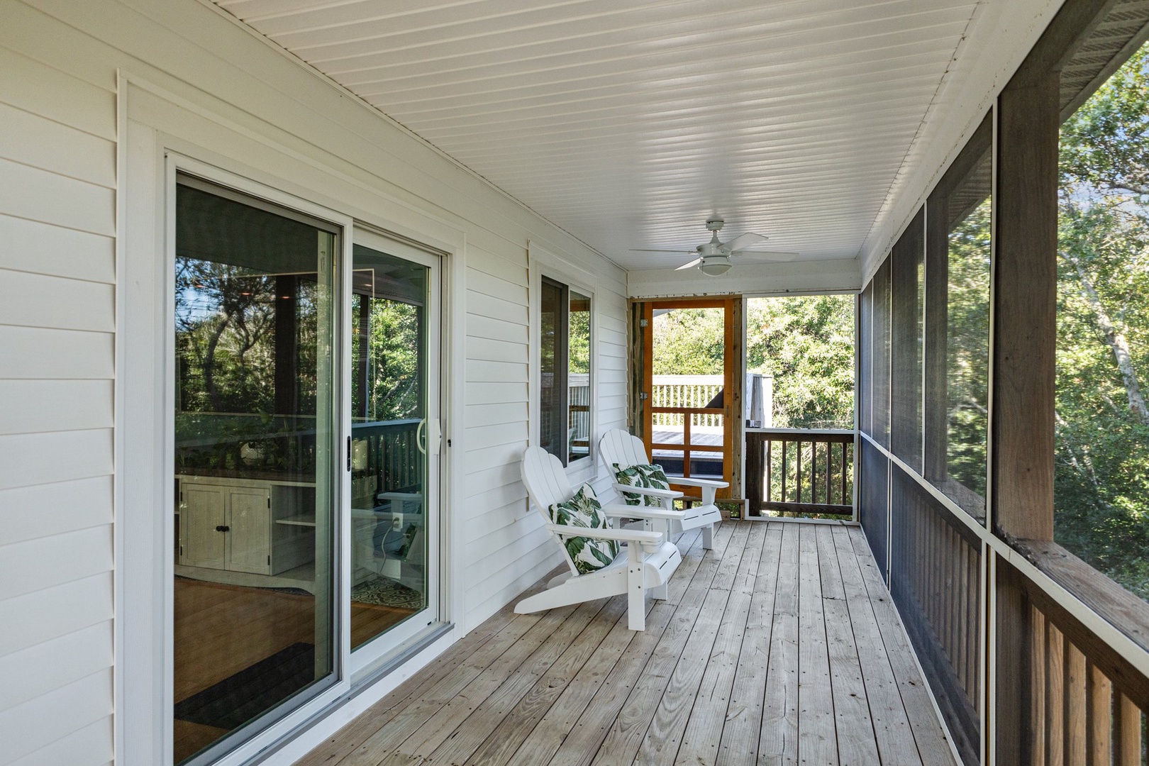 Unwind on your private covered porch with comfortable seating and peaceful forest views surrounding you.