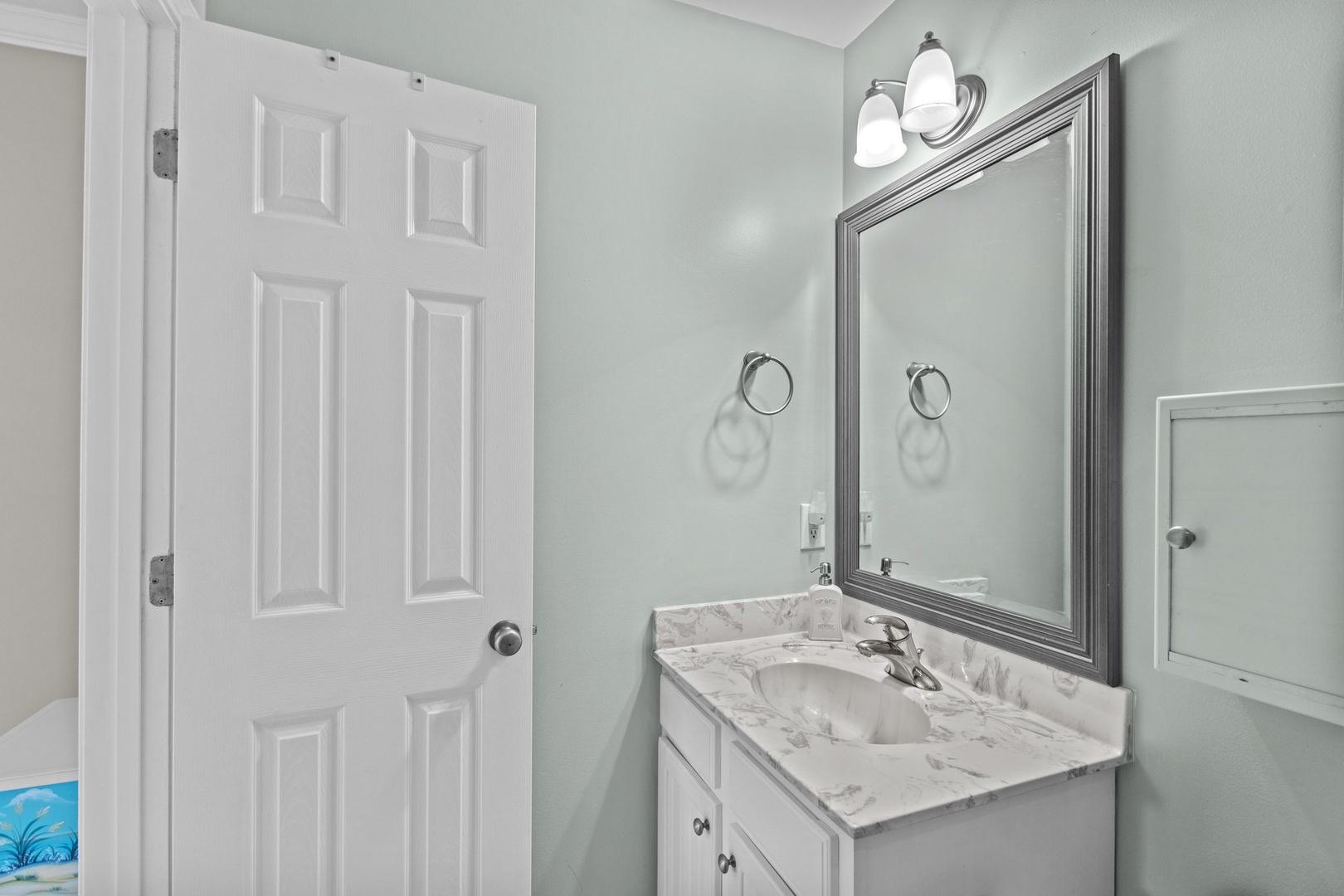 Step into your serene bathroom sanctuary with elegant marble countertops, soft lighting, and calming mint green walls for your morning routine.