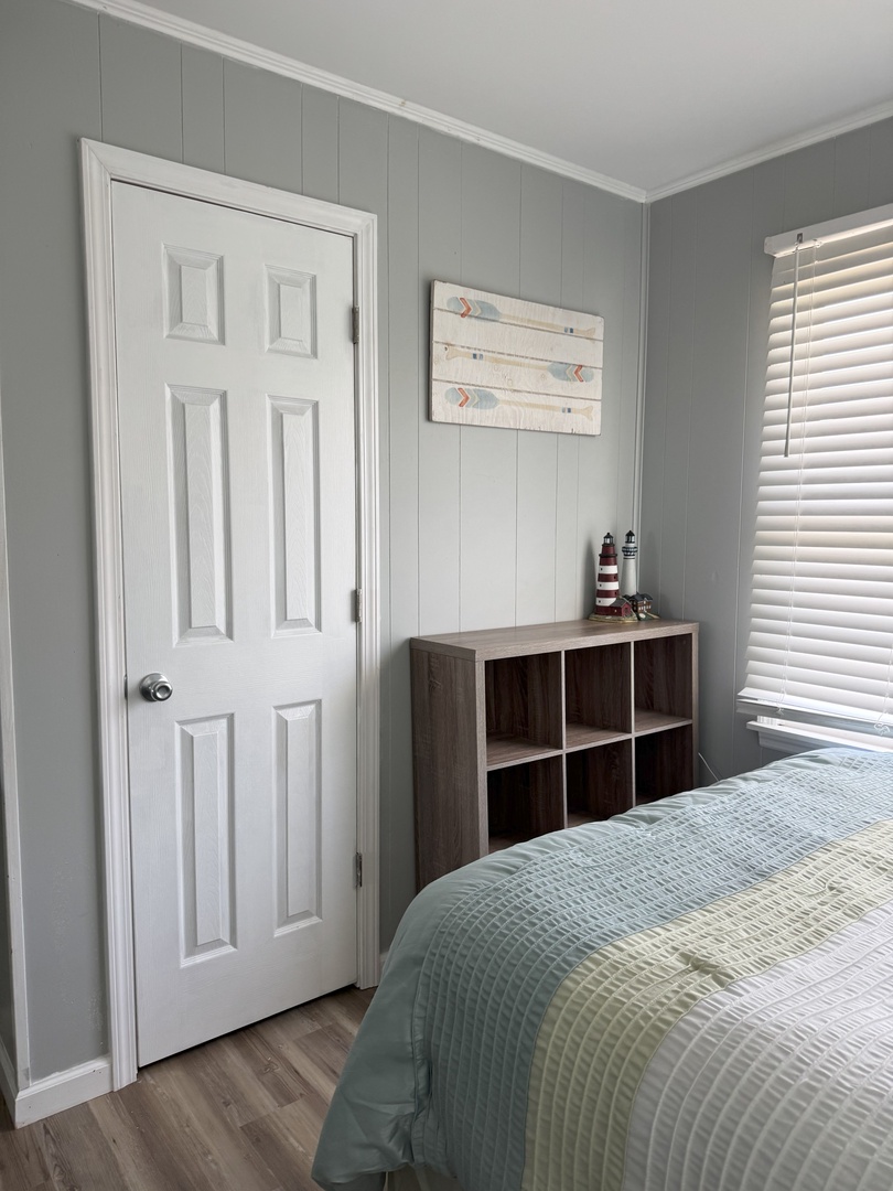 Your bedroom features soft sage tones and coastal charm with handy storage cubbies for your belongings.