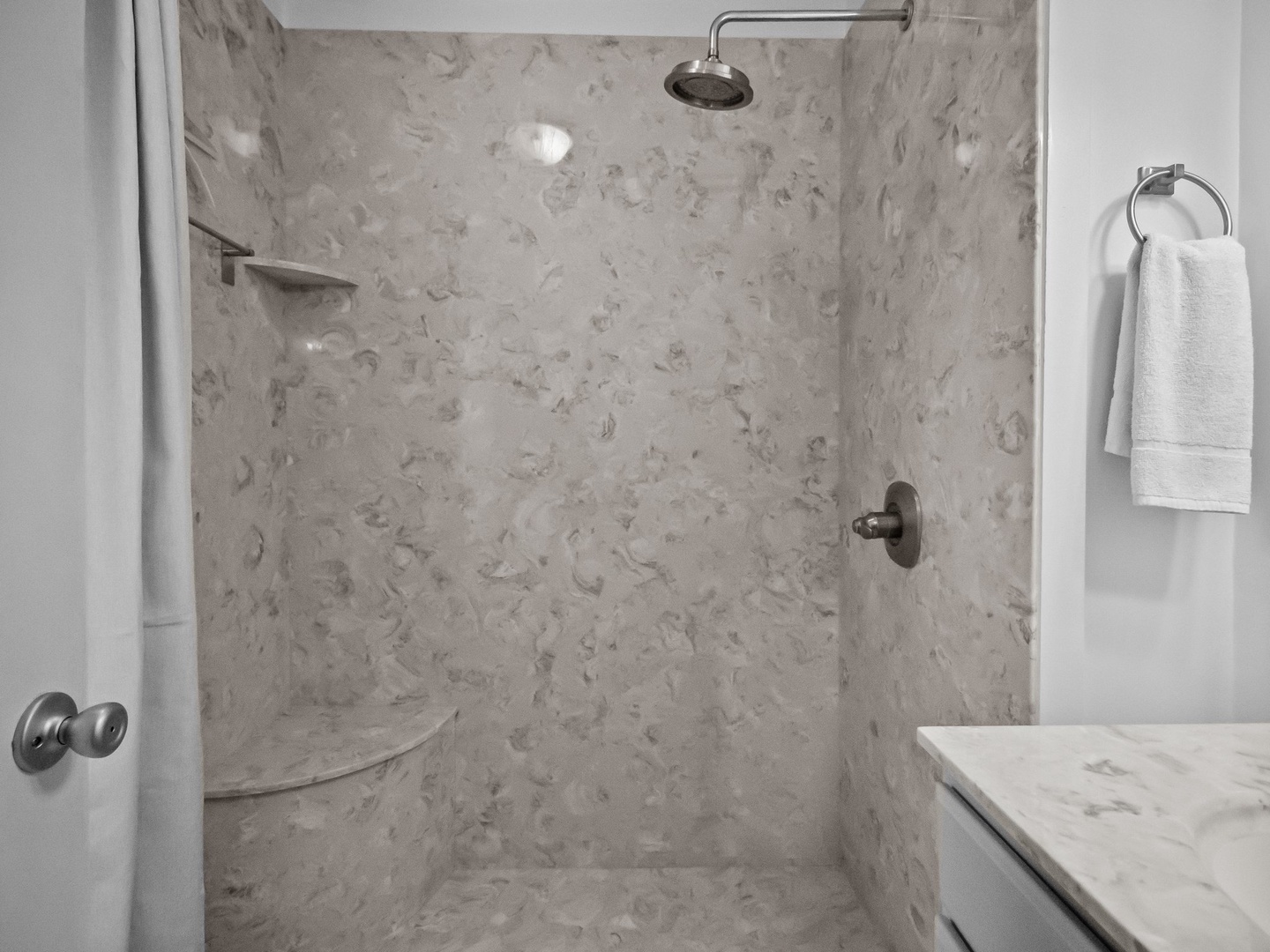 Step into your luxurious marble shower with rainfall head and built-in seating—your private spa awaits.