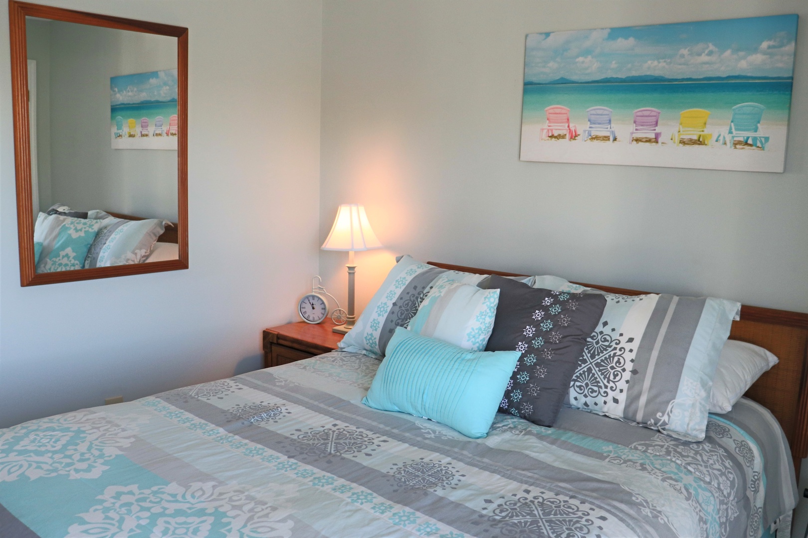 Drift off to sleep in this cozy bedroom, where beach artwork and soft bedding create your perfect coastal retreat.