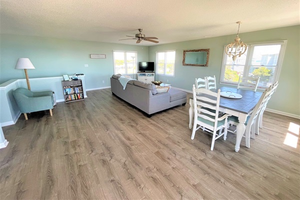 Unwind in your spacious open-plan living space with modern furnishings and abundant natural light streaming through picture windows.