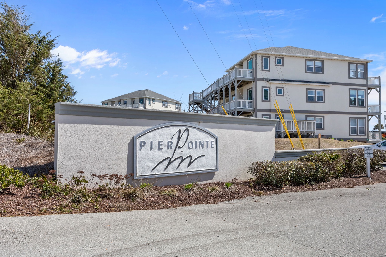 Pier Pointe entrance welcomes guests to multi-story beachfront accommodations with modern coastal architecture.