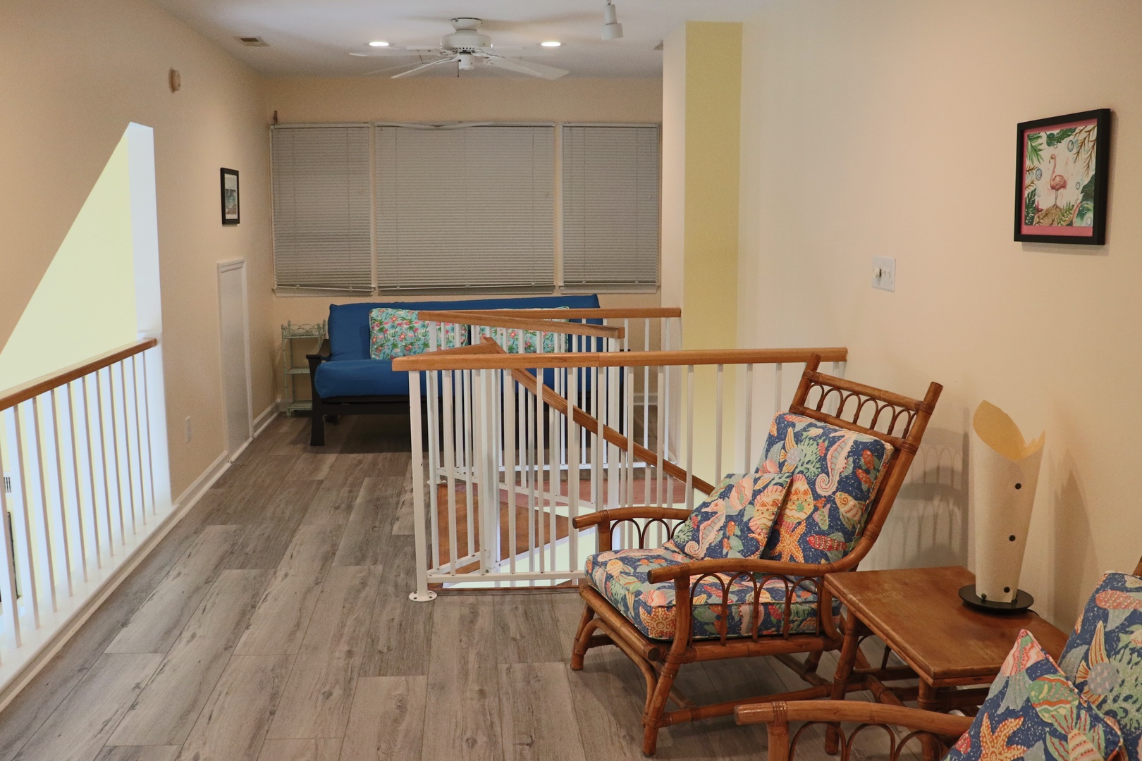 Relax in your upstairs retreat with tropical-print seating and ocean breezes from the ceiling fan overhead.