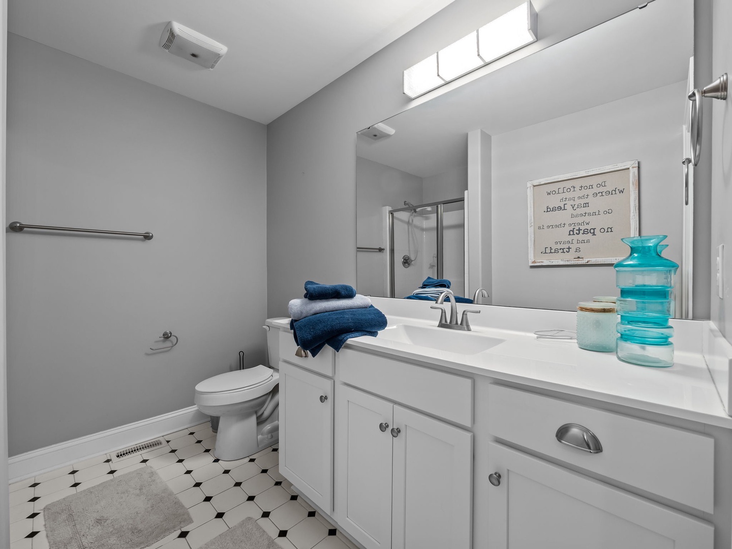 Your private bathroom features modern amenities with plush towels and thoughtful touches for a relaxing stay.