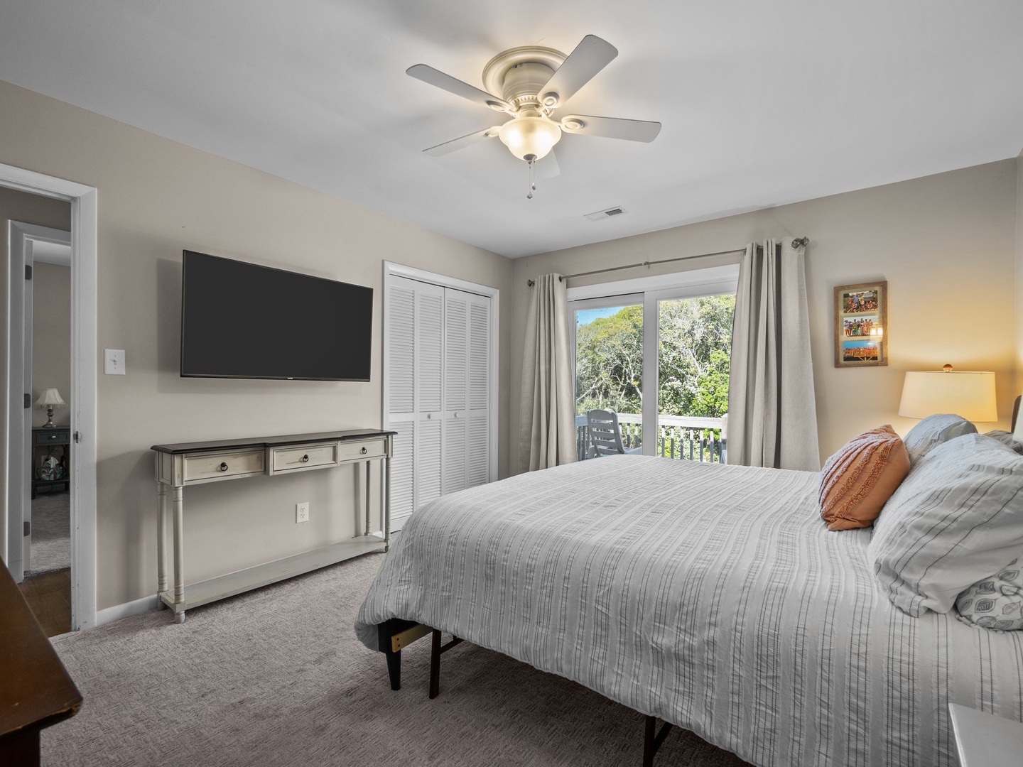 Relax in this peaceful bedroom where soft linens meet natural light streaming through your private balcony doors.