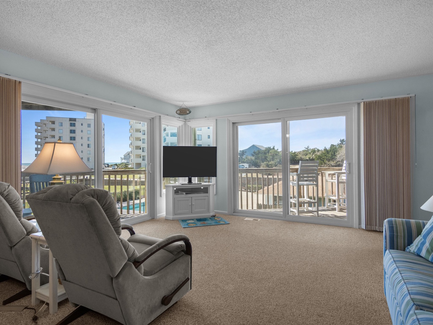 Sink into comfortable seating while enjoying panoramic views through floor-to-ceiling windows in your bright, airy living space.