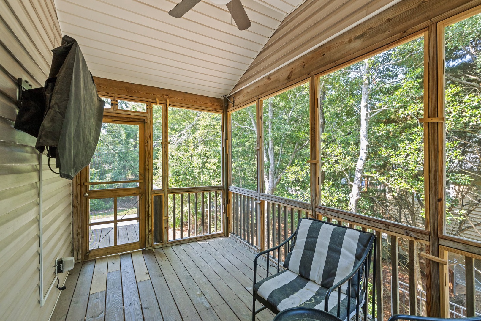 Your screened porch offers peaceful tree views while you relax in comfortable seating, perfect for morning coffee or evening unwinding.