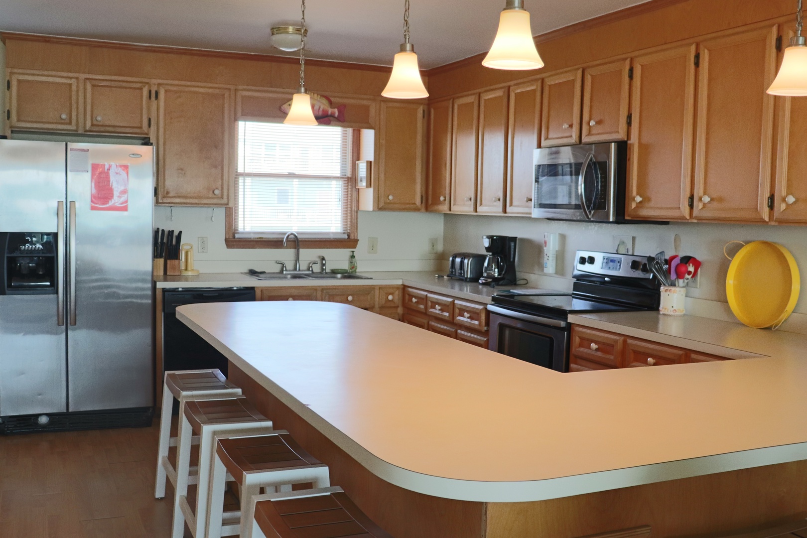 Your spacious kitchen features stainless steel appliances, warm wood cabinets, and a large island perfect for cooking memorable vacation meals together.