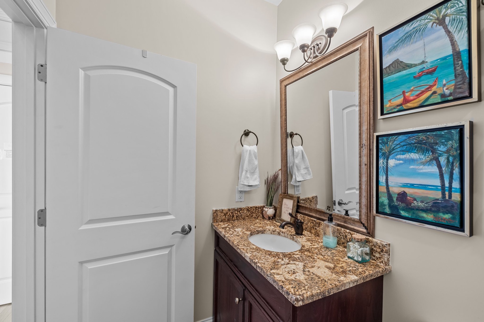 Your beautifully appointed bathroom features granite countertops, tropical artwork, and thoughtful amenities for your comfort and relaxation.