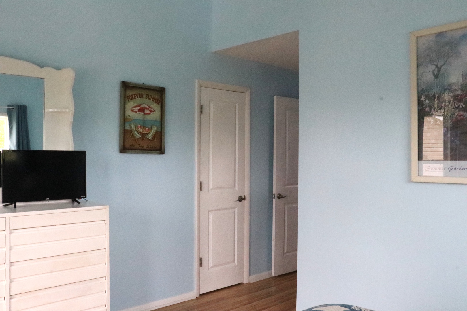 Step into your cozy coastal retreat with calming blue walls and charming decor that welcomes you home after beach adventures.