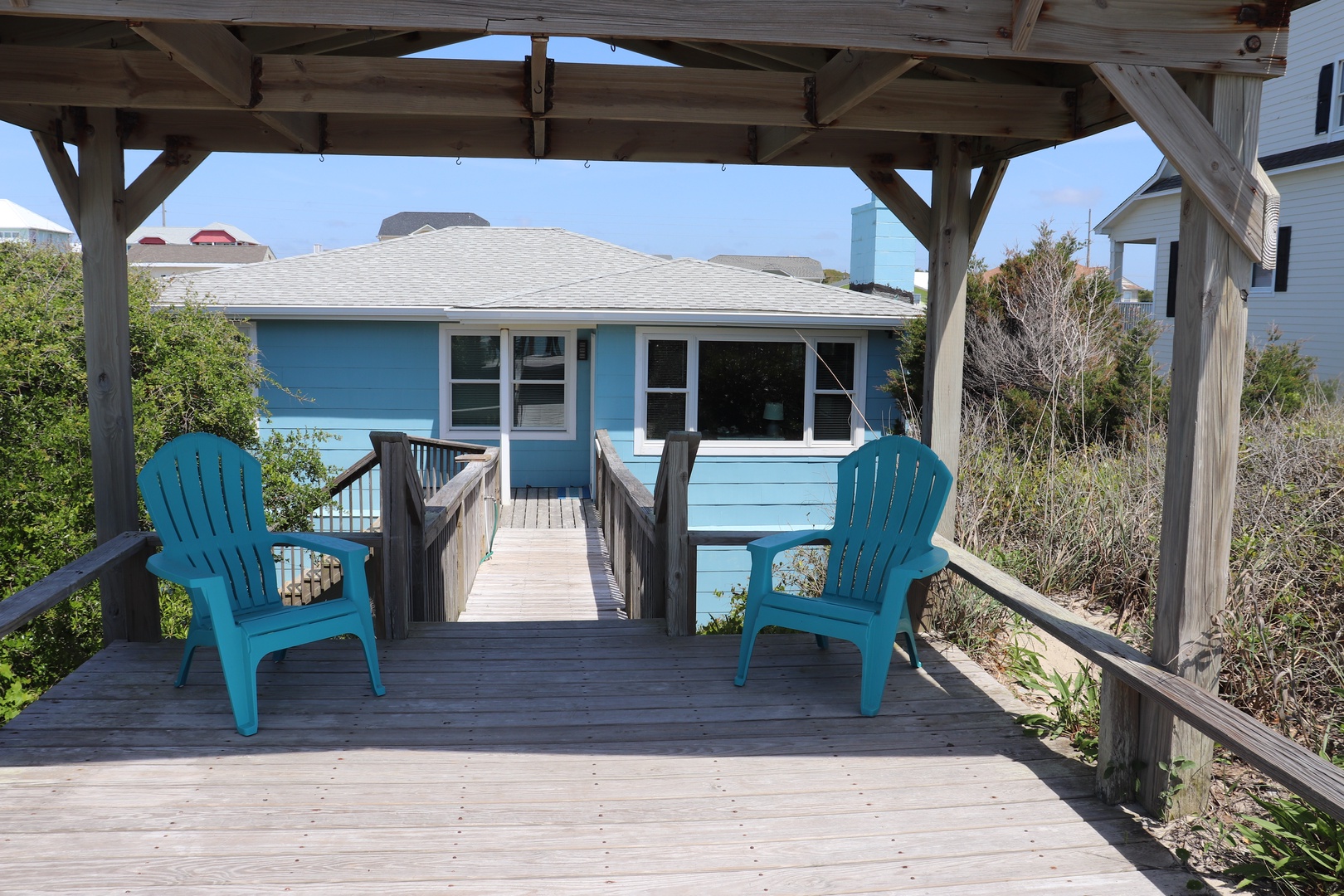 Relax in your private turquoise Adirondack chairs on this covered deck, perfectly positioned to soak up coastal breezes.