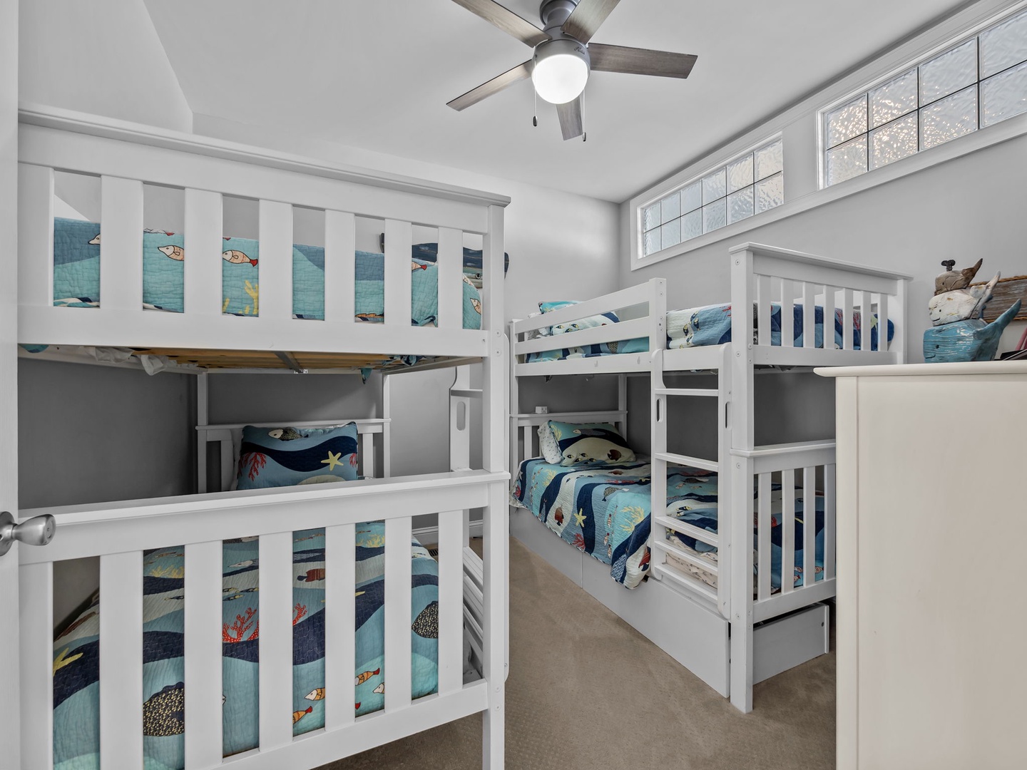 Your kids will love this fun bunk room with ocean-themed bedding and plenty of space for everyone to rest after beach adventures.
