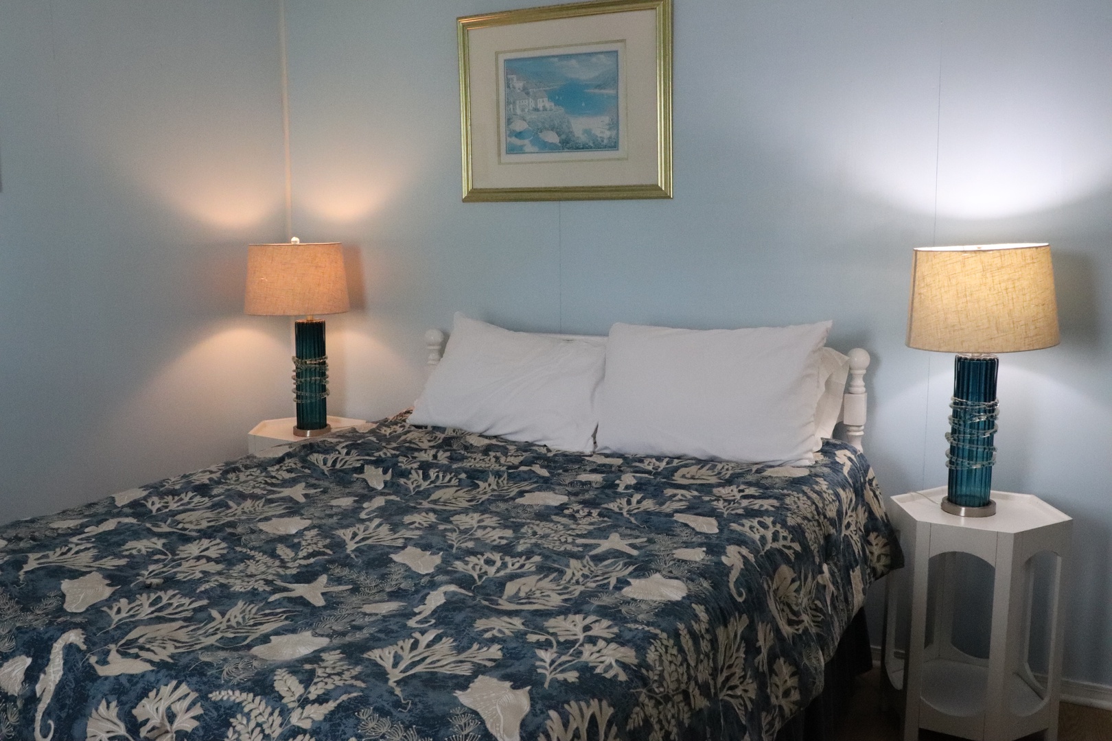 Sink into soft linens and coastal charm—your serene bedroom retreat features elegant bedside lighting and soothing ocean-inspired decor to help you unwind after a day of exploring.