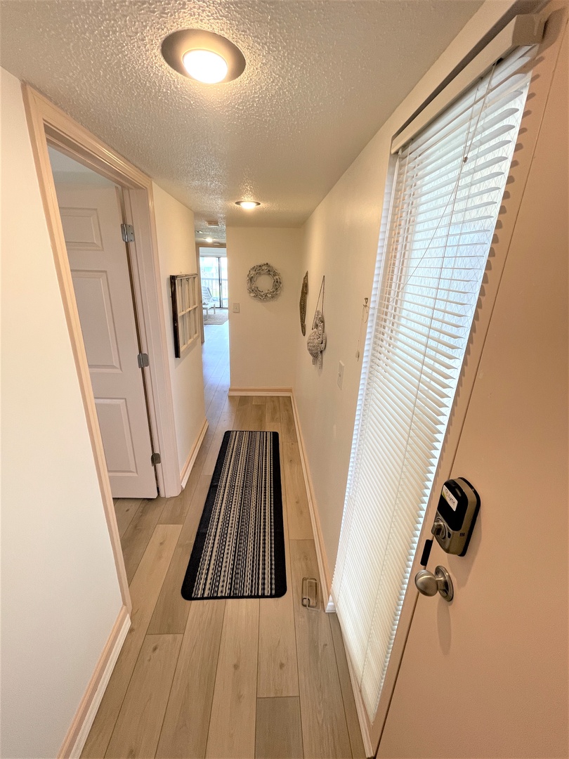 Step into your welcoming entryway with bright natural light streaming through the blinds, creating a warm first impression as you arrive home.