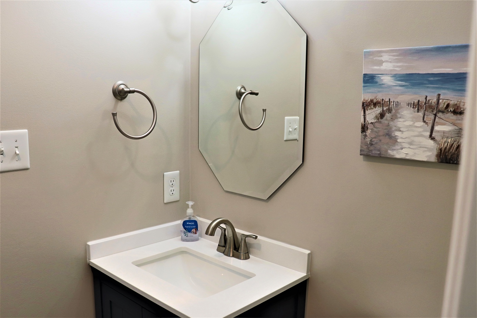 Step into your clean, thoughtfully appointed bathroom with beach-inspired décor that sets a peaceful coastal mood for your stay.