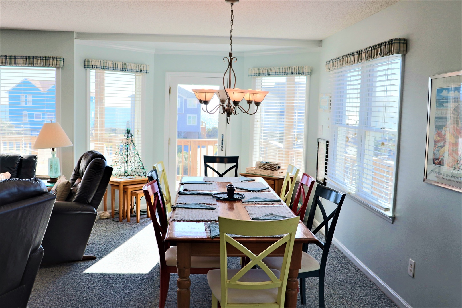 Gather around your bright dining space where colorful chairs invite memorable meals with mountain views streaming through expansive windows.