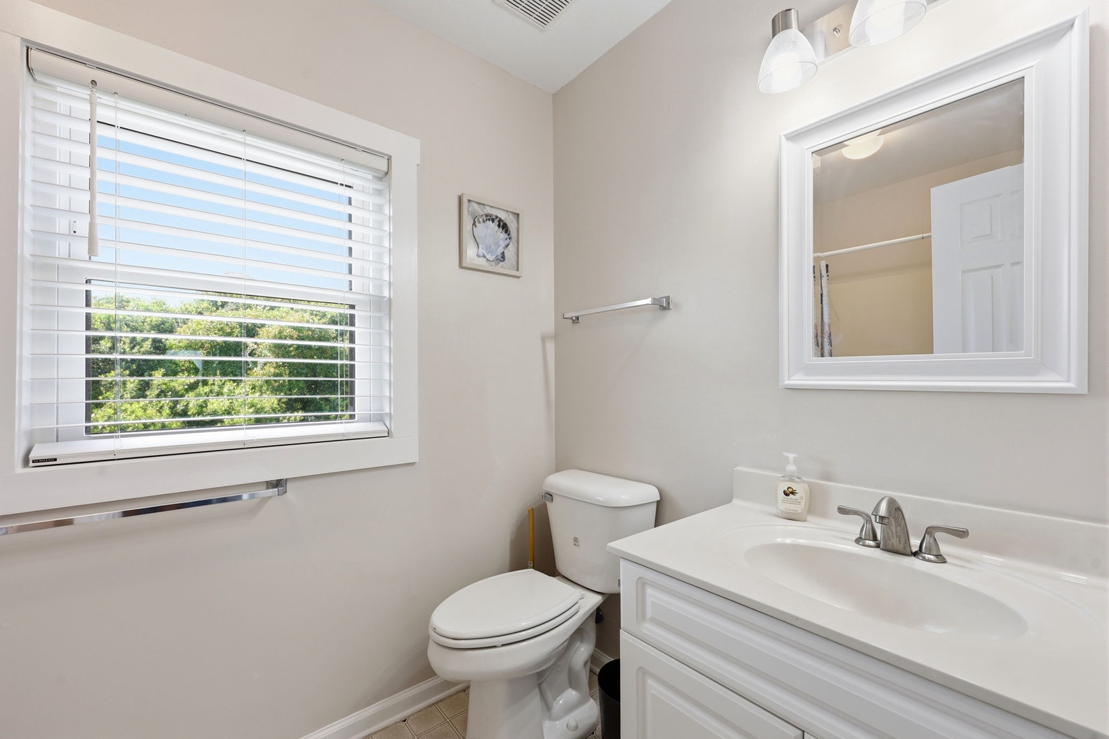 Bright, spotless bathroom with fresh linens and natural light—your private retreat to freshen up after a day exploring the area.