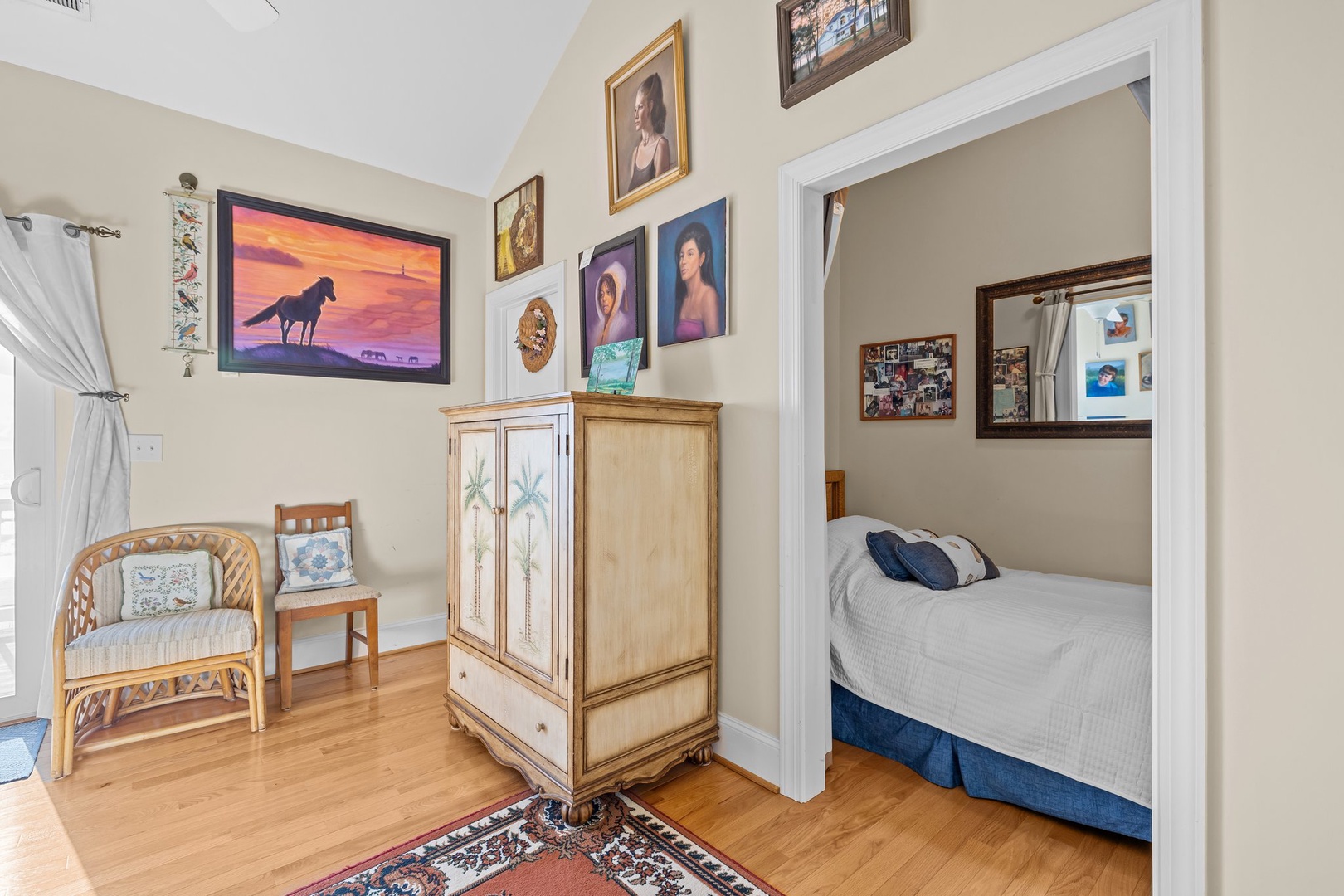 Relax in your charming bedroom with warm wood floors, cozy seating, and personal touches that make this space feel like home.