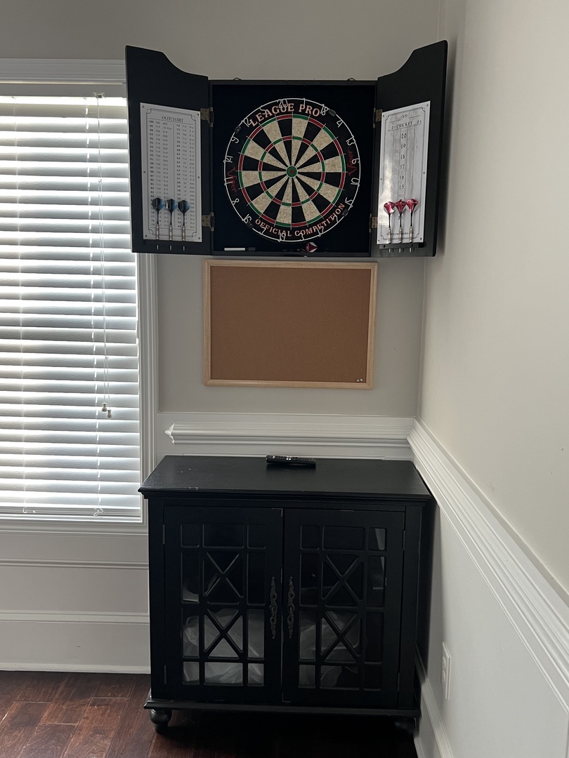 Challenge friends to darts in your private game room, complete with professional dartboard and scoring system for endless entertainment.