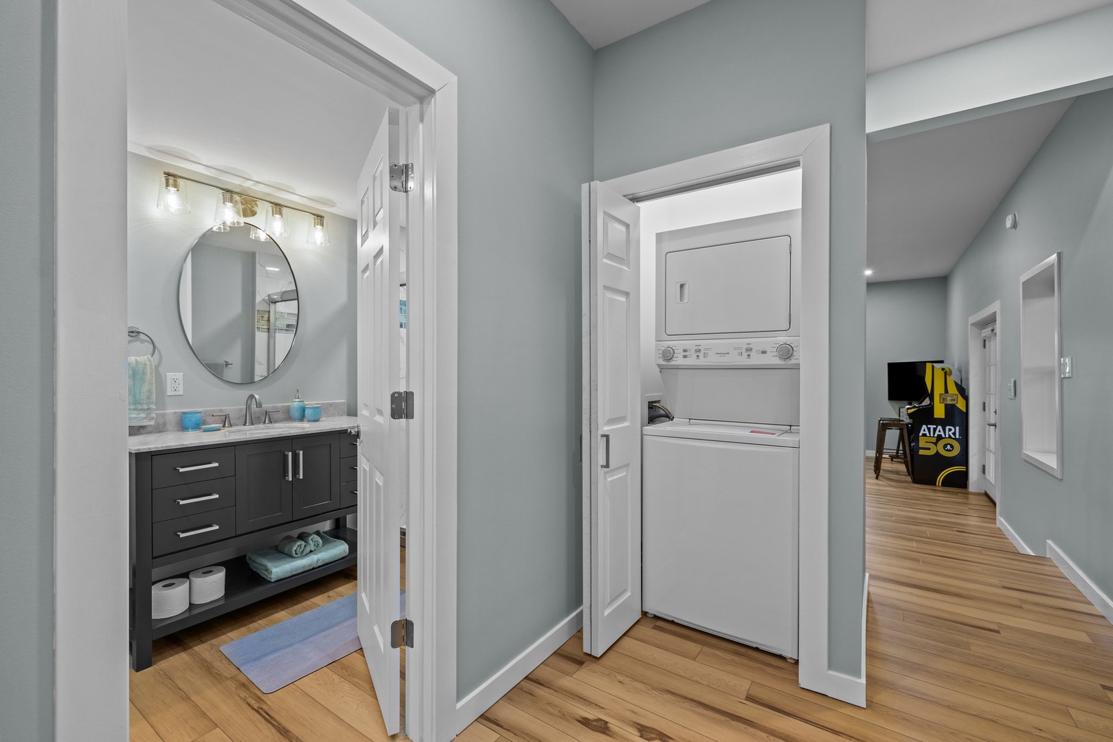 Your modern bathroom and laundry nook offer convenience with stacked washer and dryer plus elegant finishes throughout.