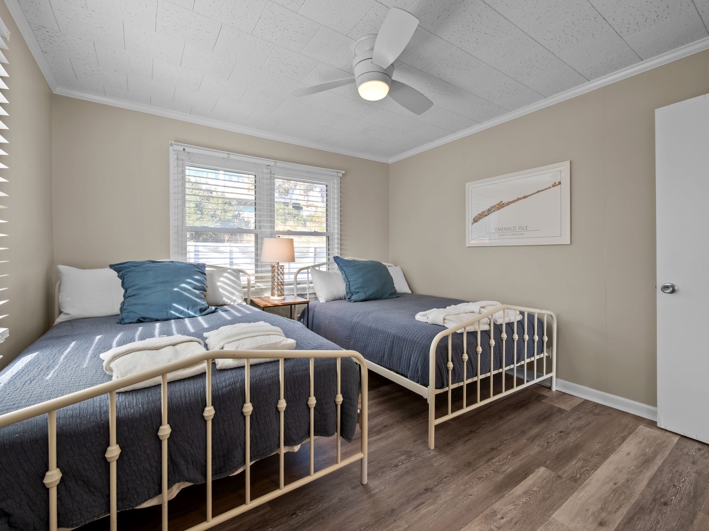 Your peaceful twin bedroom features comfortable beds with soft linens and natural light streaming through the windows.