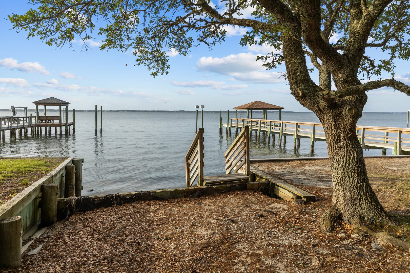 Waterfront property featuring private dock access and scenic bay views with peaceful fishing piers nearby.