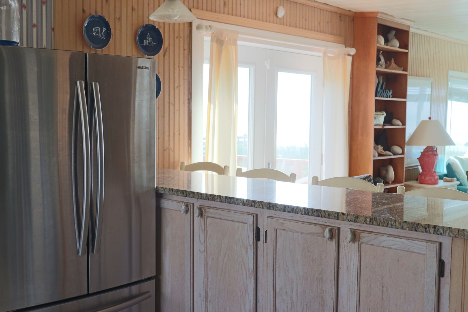 Your fully equipped kitchen features granite countertops, stainless steel appliances, and warm wood cabinetry for cooking memorable meals.