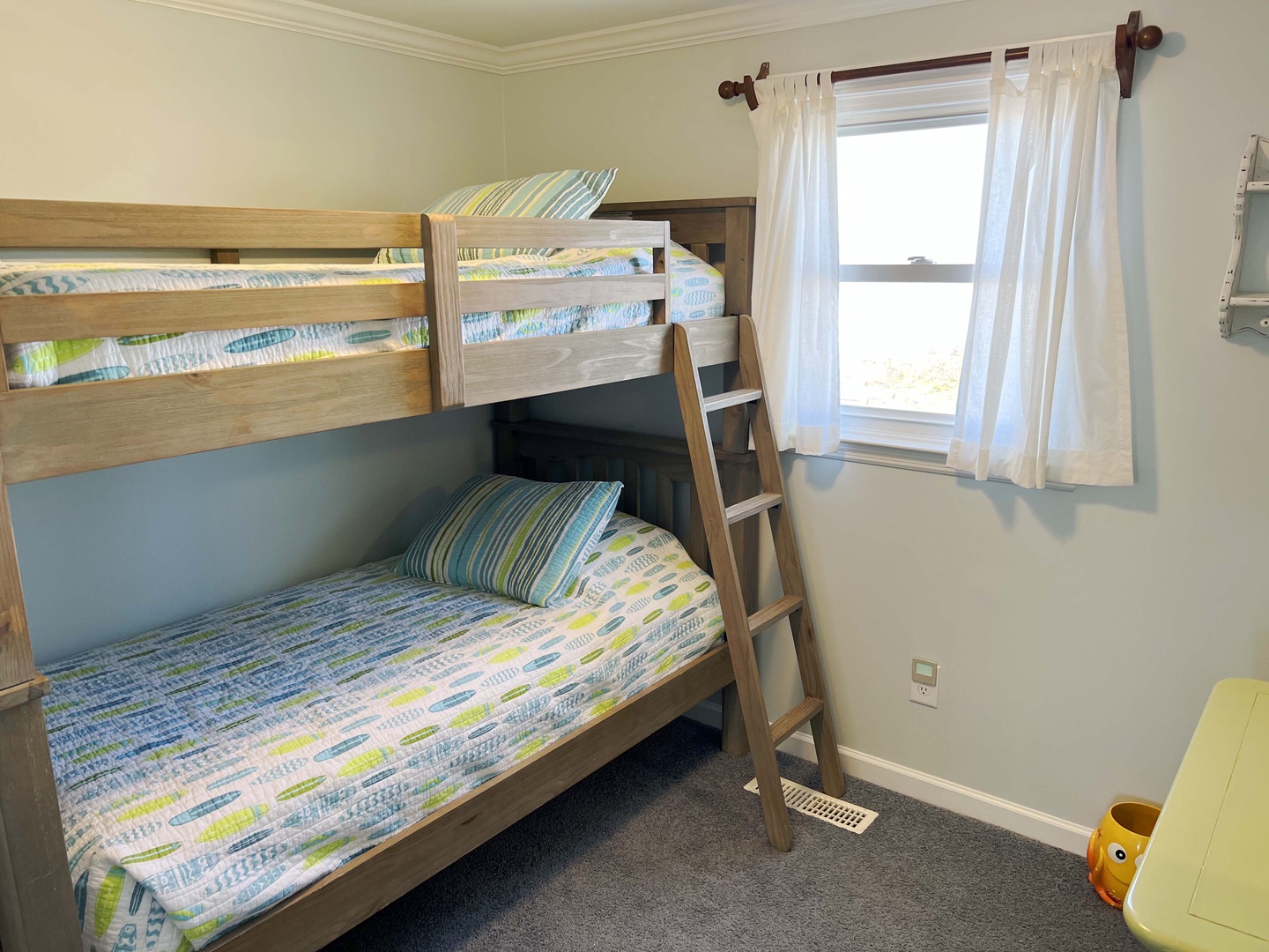 Your kids will love this cheerful bunk bed room with soft natural light and playful bedding.