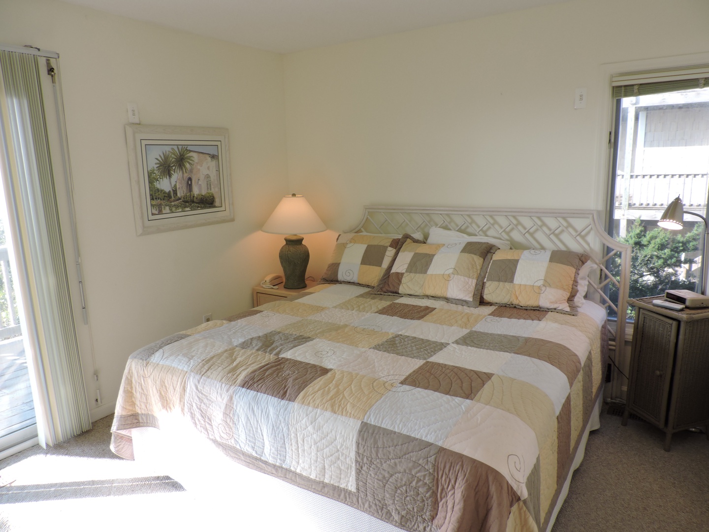 Drift into peaceful slumber in your bright, airy bedroom with plush quilted bedding and gentle natural light streaming through your private balcony doors.