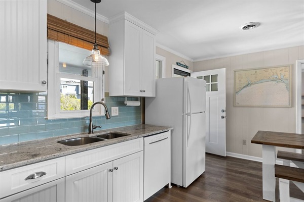 Your fully equipped kitchen features granite counters, stainless appliances, and charming subway tile backsplash—perfect for preparing memorable meals during your stay.