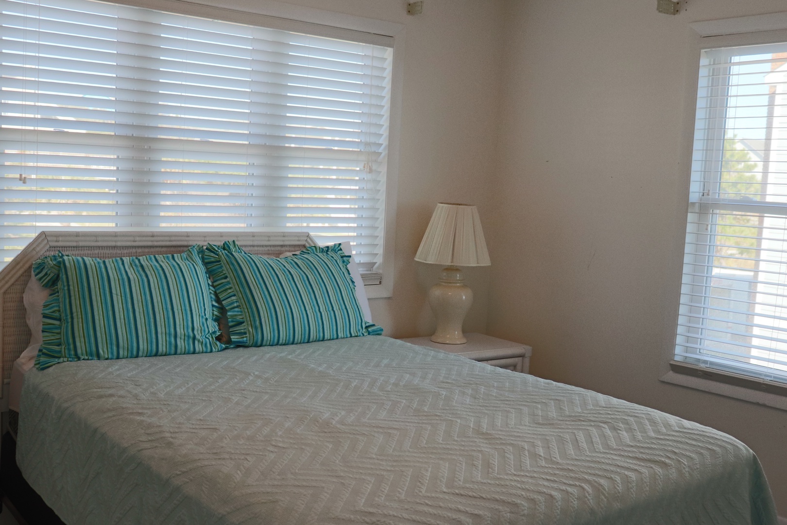Drift into peaceful sleep in this bright, airy bedroom with soft coastal linens and gentle natural light filtering through your windows.