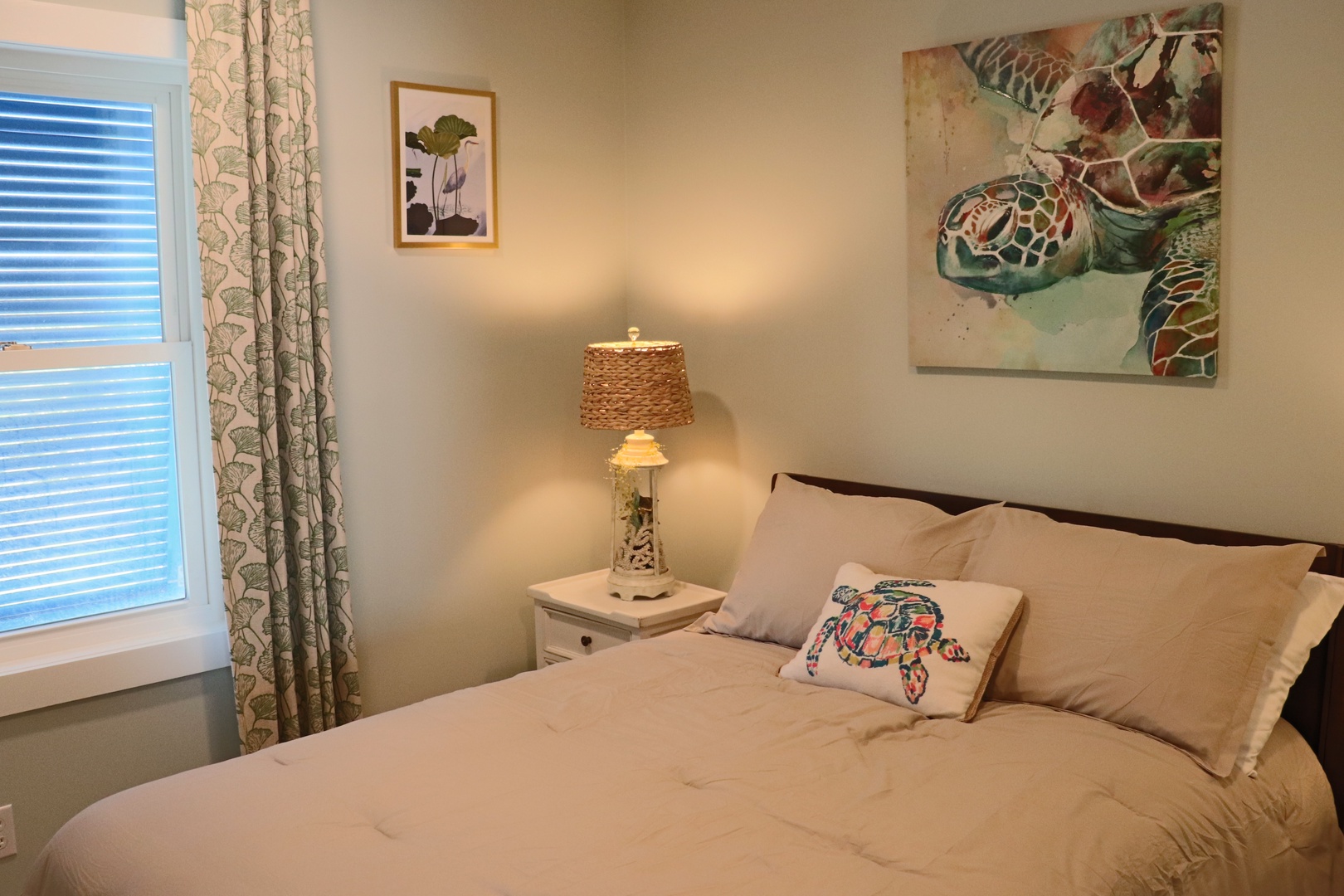 Sink into your peaceful retreat with ocean-themed artwork and soft lighting creating the perfect ambiance for restful nights.