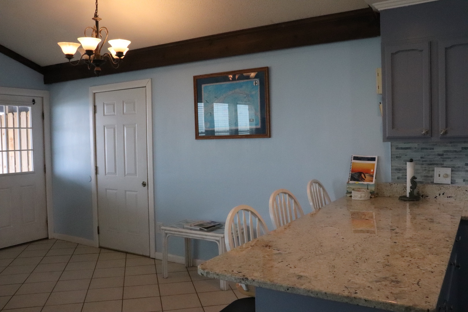 Your spacious kitchen features a large granite island perfect for meal prep and casual dining, with charming coastal décor that brings a relaxed, beachy vibe to your stay.