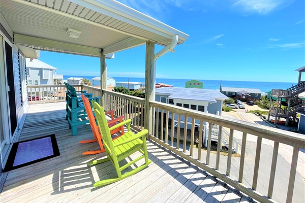 Relax in colorful rocking chairs on your covered deck while soaking up stunning ocean views and gentle sea breezes.