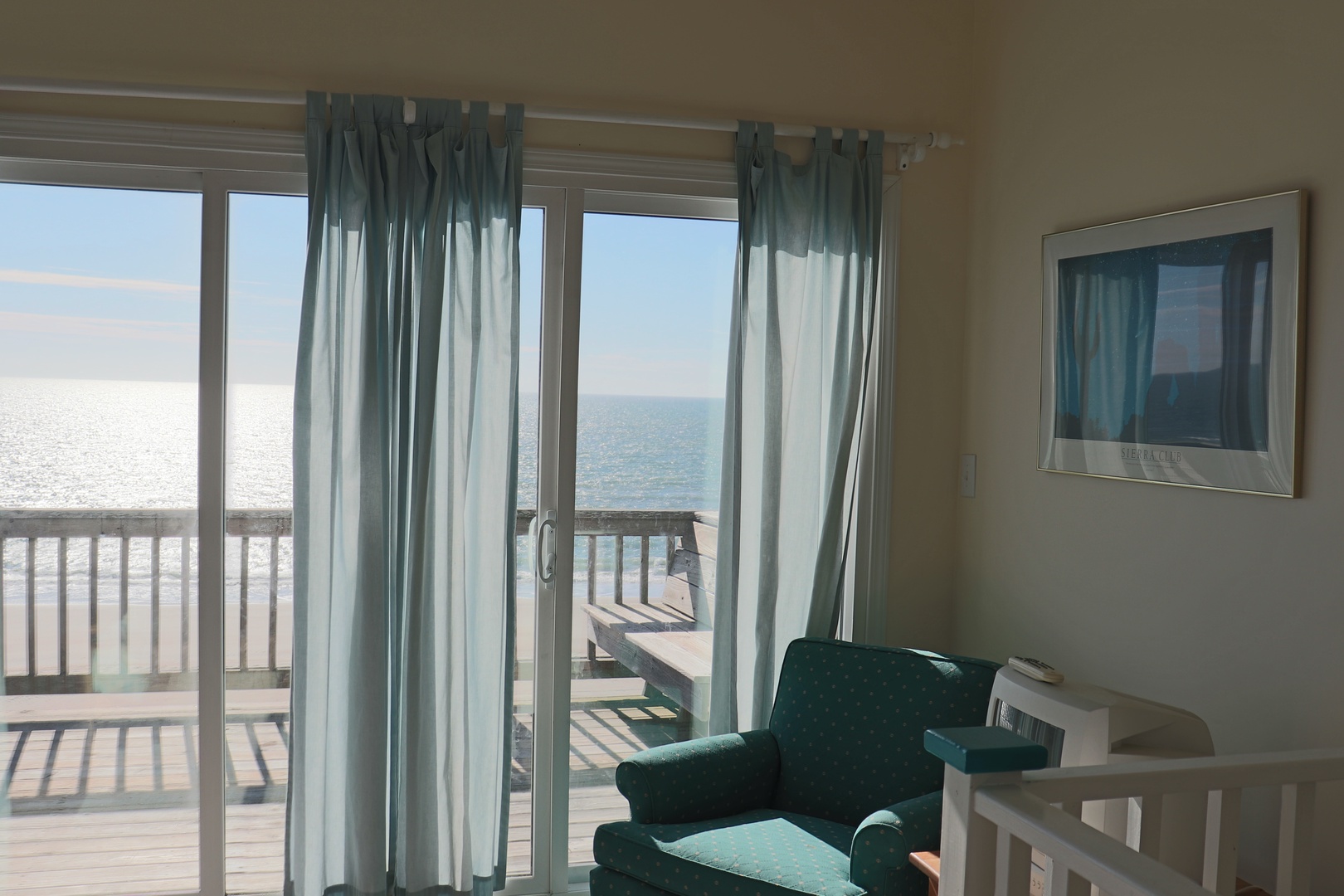 Relax in your cozy chair while taking in stunning ocean views through floor-to-ceiling windows that frame the endless sea.