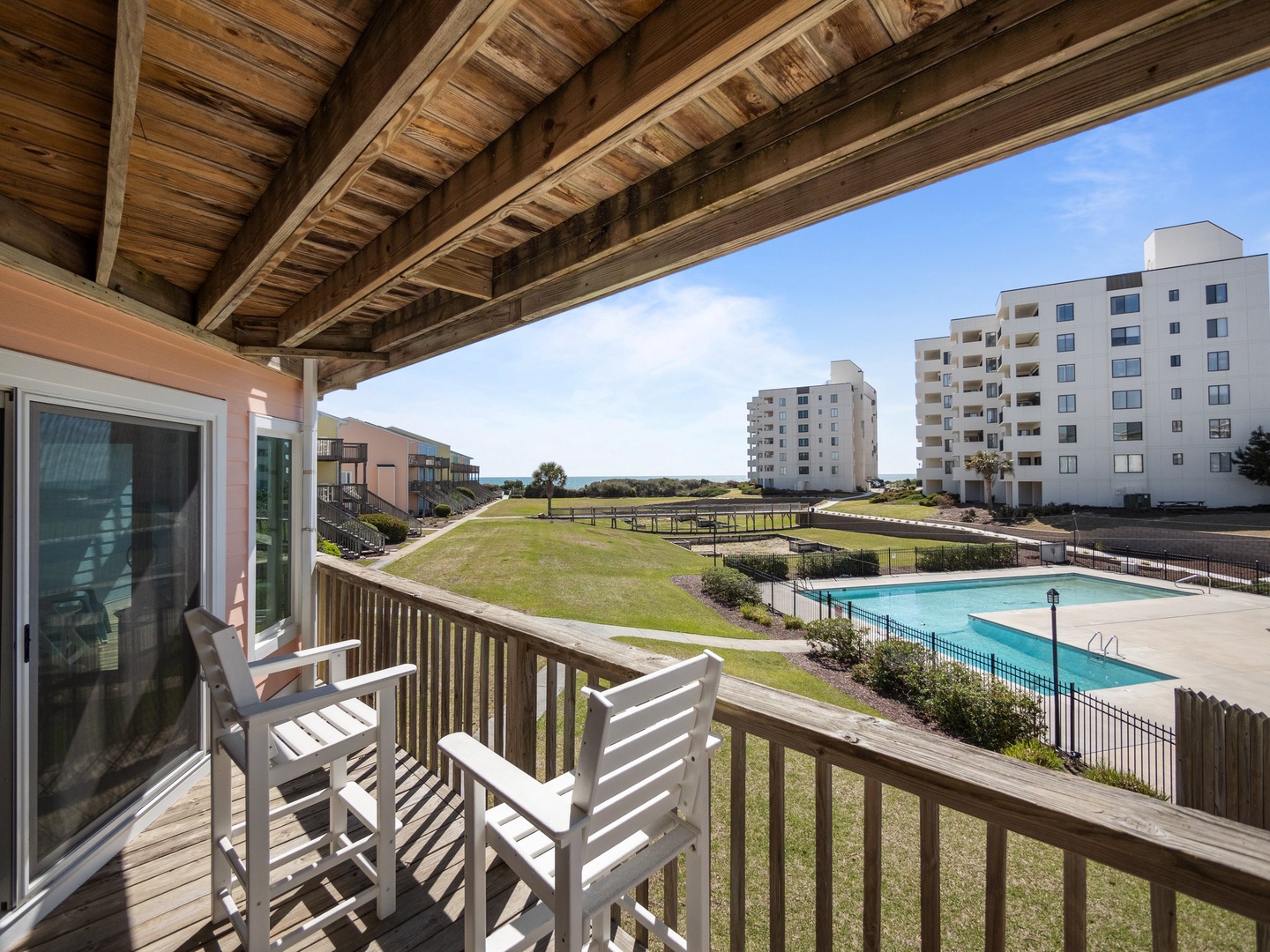 Step onto your private balcony and breathe in the fresh coastal air while enjoying stunning views of the community pool and ocean beyond.