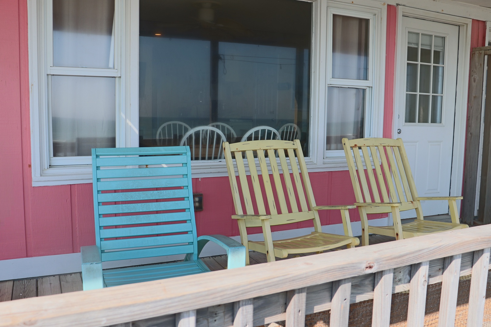 Relax on your private deck with colorful chairs, perfect for morning coffee or evening conversations.