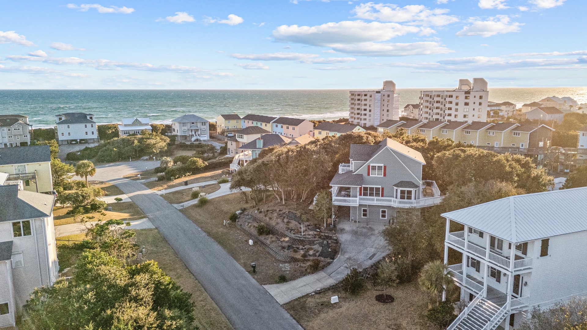 Coastal community with beach homes nestled among natural dunes, offering peaceful oceanside living just steps from the shore.