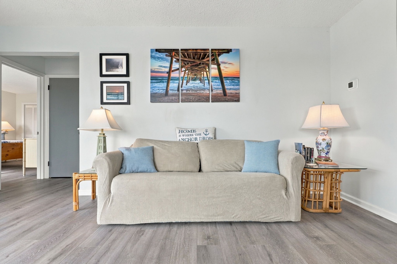 Unwind in your bright, coastal-inspired living room, where soft neutral tones and ocean-themed touches create a relaxing retreat after a day at the beach.