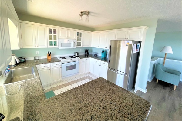 Cook meals in your bright, fully equipped kitchen with granite countertops, stainless steel appliances, and plenty of cabinet storage space.