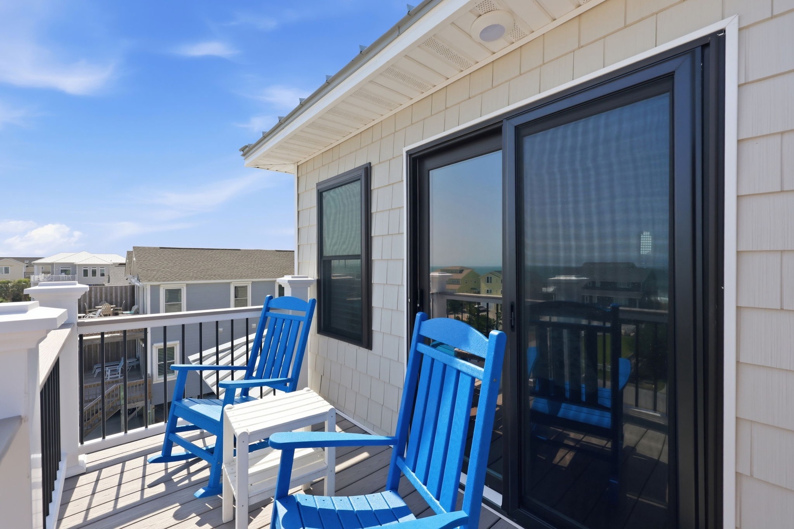 Picture yourself relaxing in these vibrant blue rocking chairs, soaking in sunshine and fresh air on your private balcony with stunning views of the coast and neighborhood.