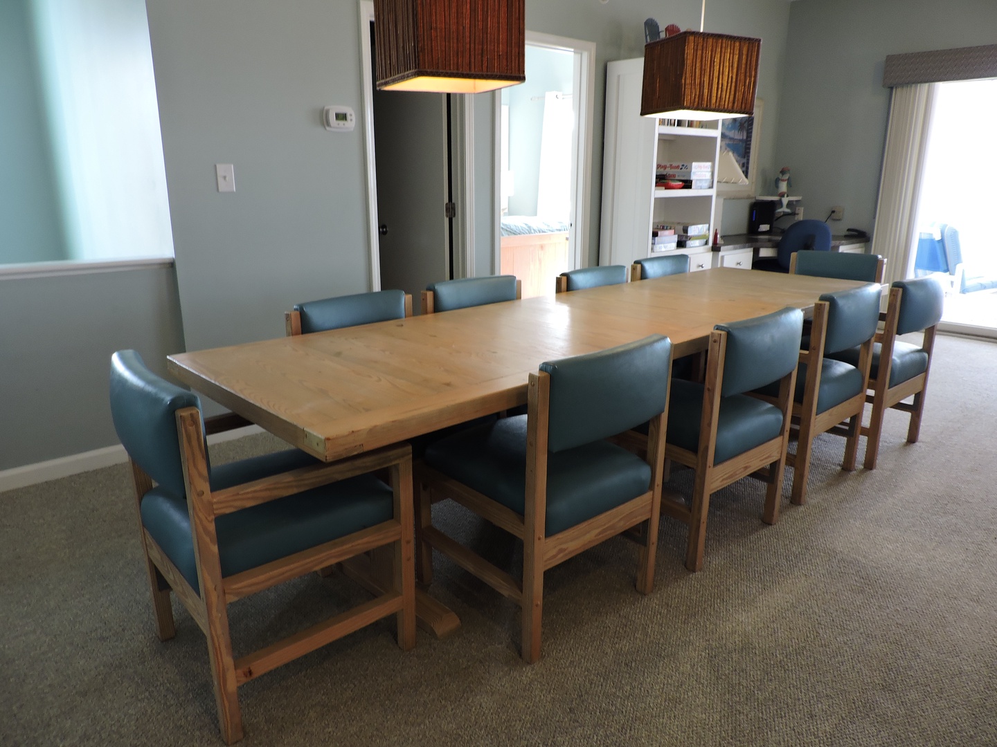 Gather around this spacious dining table for memorable meals with your group, surrounded by comfortable seating and warm natural light.