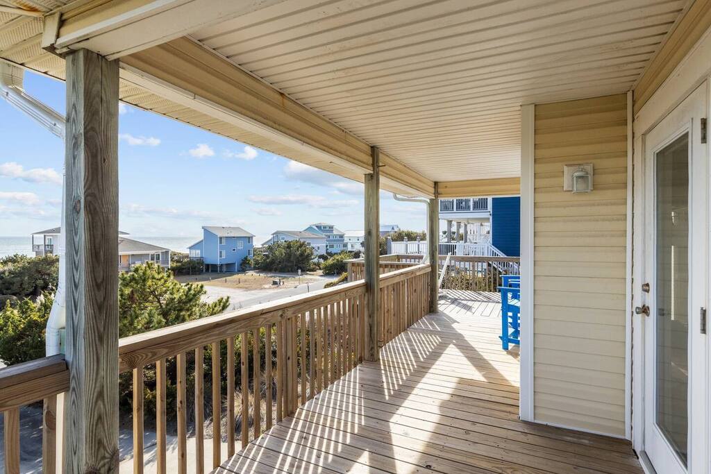 Step onto your private deck where coastal breezes and charming beach house views create the perfect spot for morning coffee.