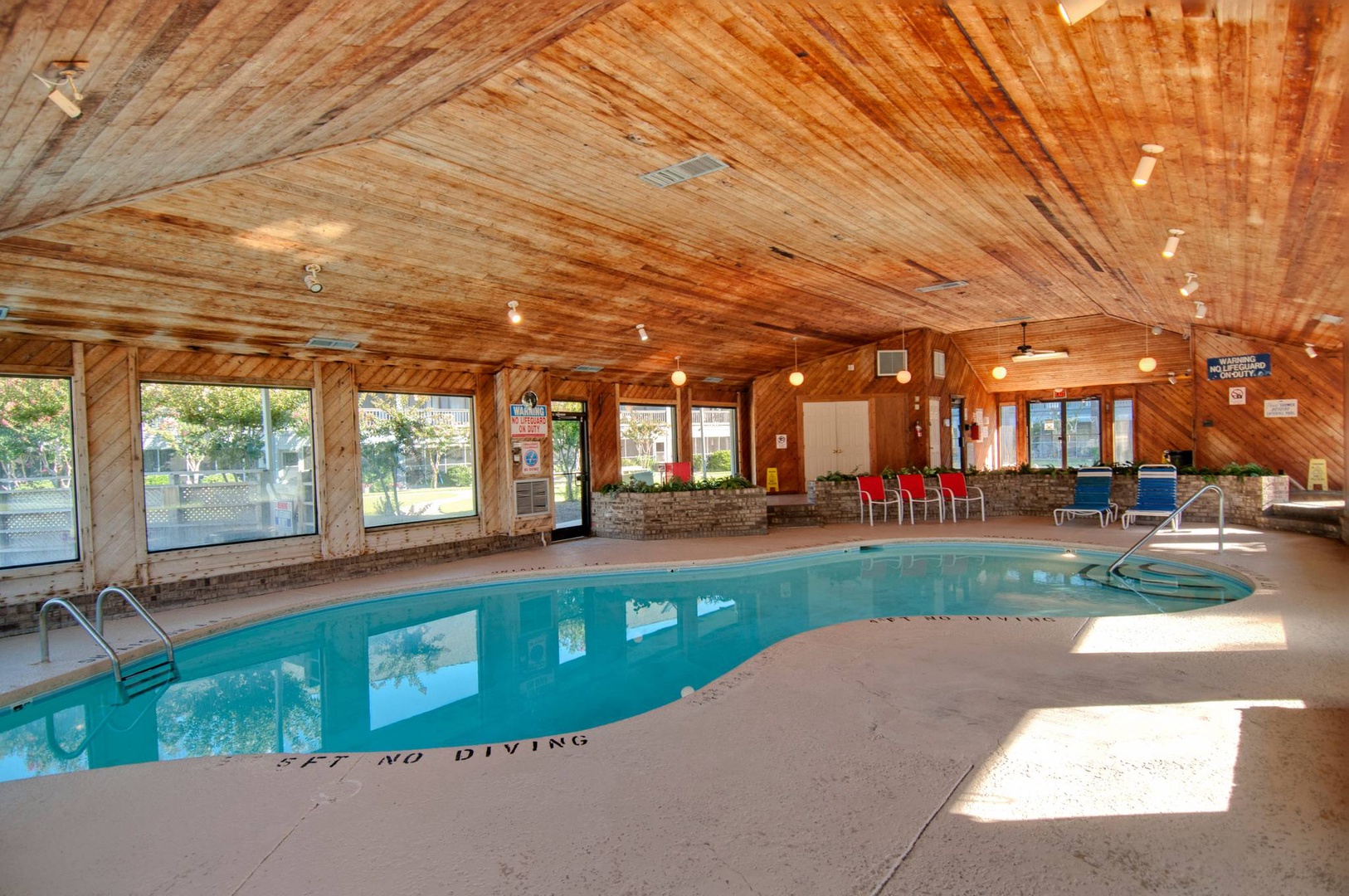 Dive into relaxation in this stunning indoor pool with soaring wood ceilings and large windows that flood the space with natural light.
