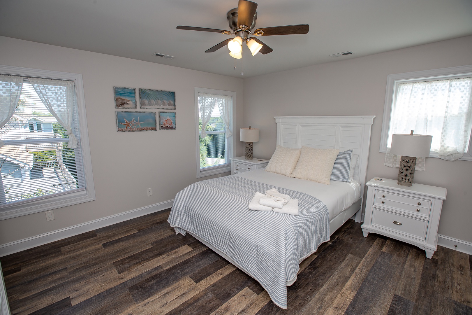 Drift off to peaceful sleep in your bright, coastal-themed bedroom with crisp linens and ocean-inspired artwork creating the perfect retreat.